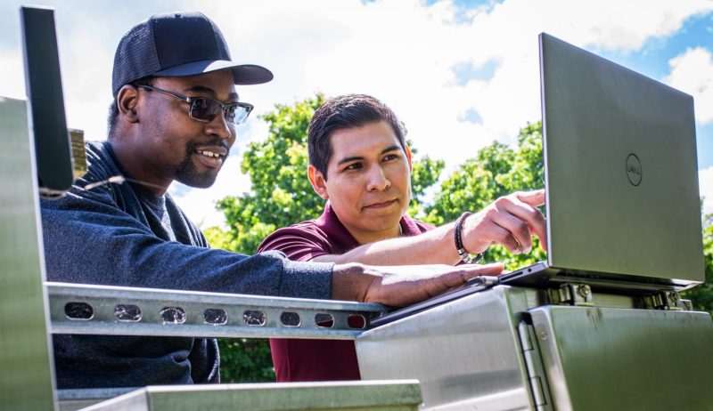 Munoz Student and Faculty analyzing data on a laptop