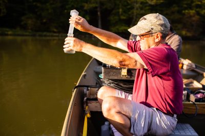 Researcher taking water sample
