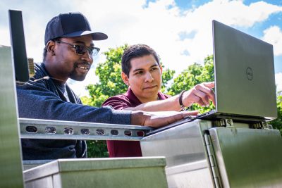 Two researchers looking at computer